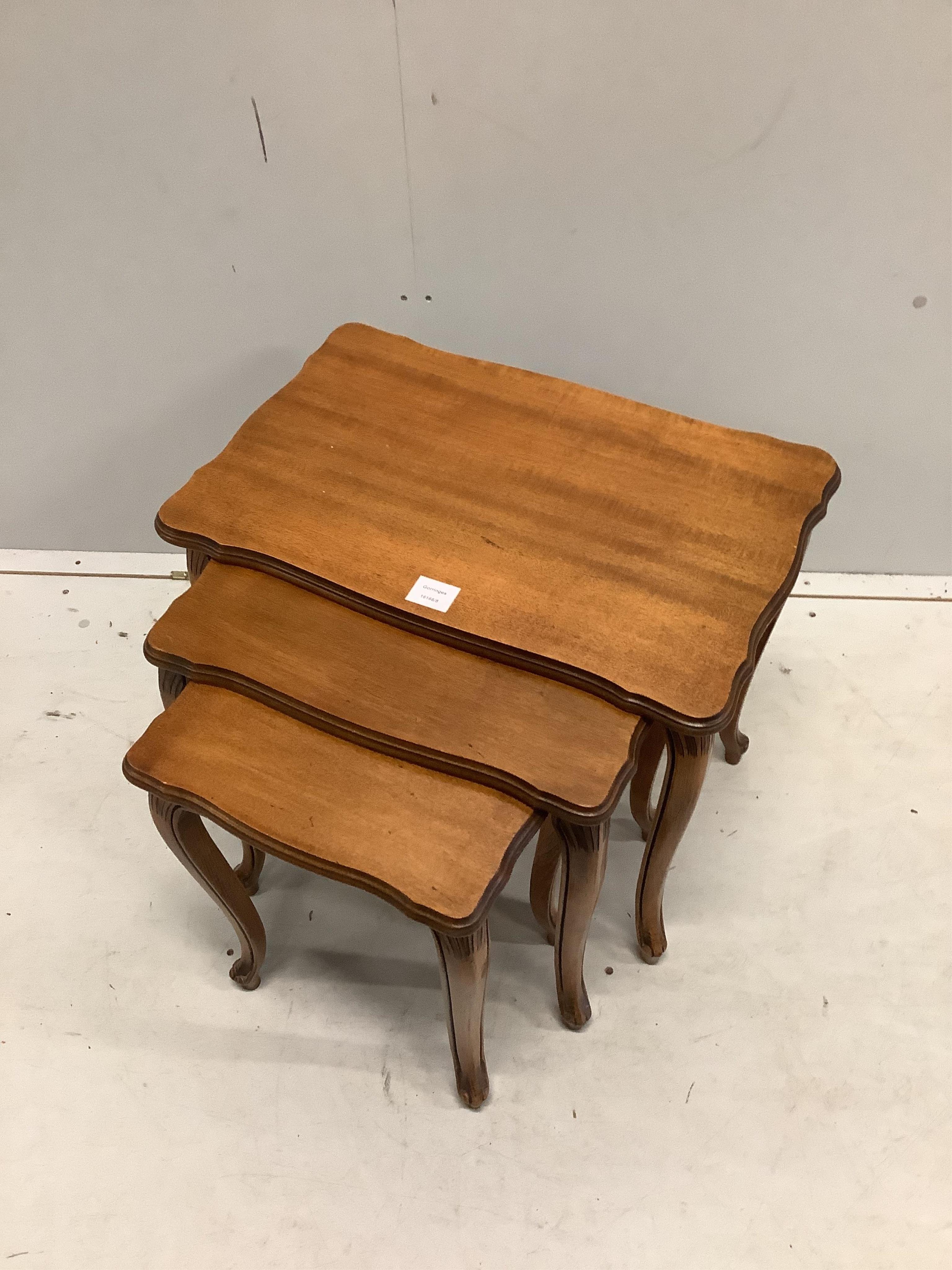 A nest of three mahogany tea tables, on slender cabriole legs, width 58cm, depth 38cm, height 49cm. Condition - good